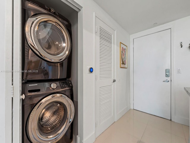 950 Brickell Bay Dr Unit 1103, Miami, FL 33131 - laundry room featuring stacked washer / drying machine and tile patterned floors