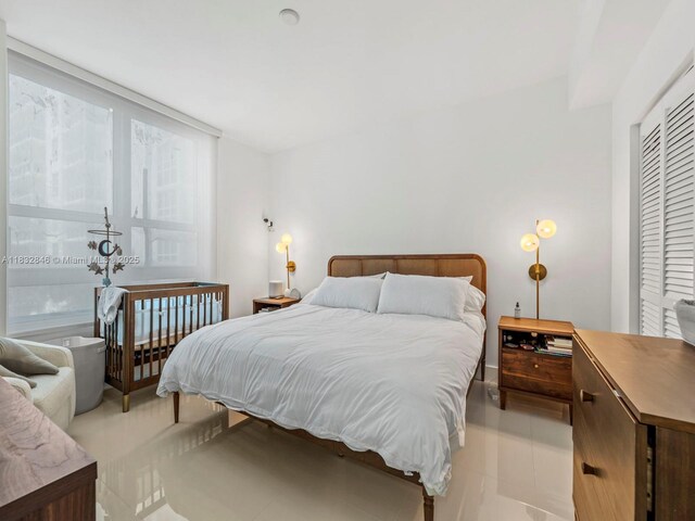 950 Brickell Bay Dr Unit 1103, Miami, FL 33131 - bedroom featuring light tile patterned floors and a closet