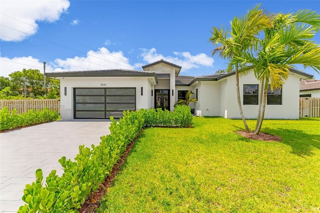 8220 SW 193rd Ter, Cutler Bay, FL 33157 - view of front of house featuring stucco siding, an attached garage, and driveway