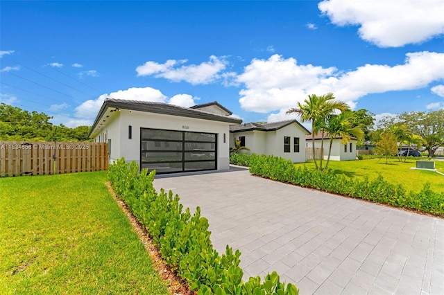 8220 SW 193rd Ter, Cutler Bay, FL 33157 - modern home with an attached garage, decorative driveway, and stucco siding