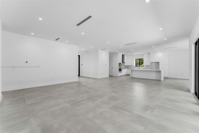 8220 SW 193rd Ter, Cutler Bay, FL 33157 - unfurnished living room with recessed lighting and concrete flooring