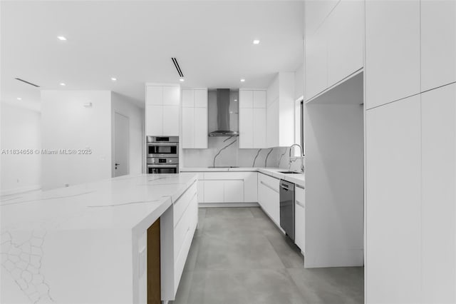 8220 SW 193rd Ter, Cutler Bay, FL 33157 - kitchen featuring modern cabinets, wall chimney range hood, appliances with stainless steel finishes, white cabinetry, and recessed lighting