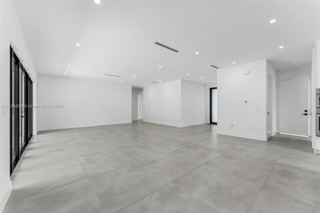 8220 SW 193rd Ter, Cutler Bay, FL 33157 - spare room featuring finished concrete flooring and recessed lighting