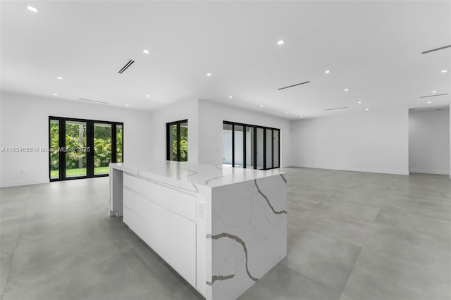 8220 SW 193rd Ter, Cutler Bay, FL 33157 - unfurnished room featuring concrete flooring, recessed lighting, and french doors