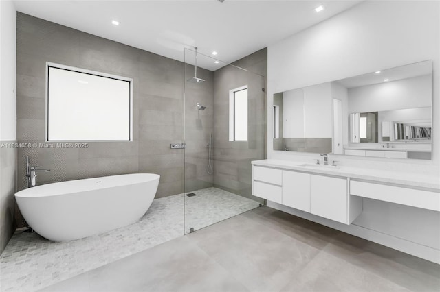 8220 SW 193rd Ter, Cutler Bay, FL 33157 - bathroom with walk in shower, vanity, a soaking tub, recessed lighting, and finished concrete floors
