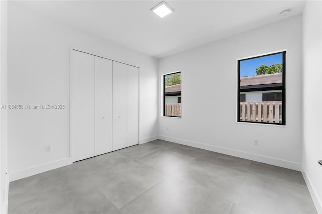 8220 SW 193rd Ter, Cutler Bay, FL 33157 - unfurnished bedroom featuring concrete floors and a closet