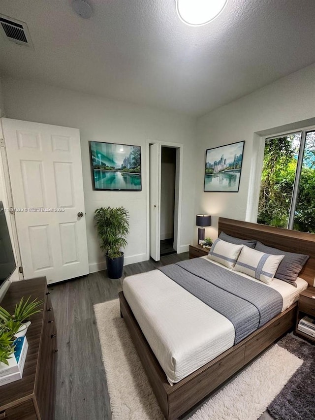 1812 NW 64th St, Miami, FL 33147 - bedroom with baseboards and dark wood-style floors