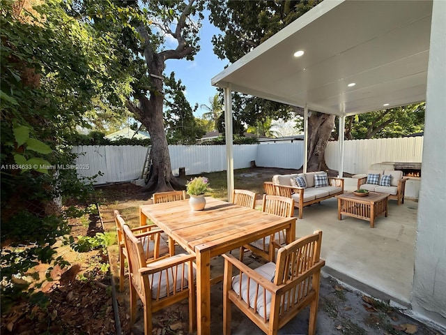 1812 NW 64th St, Miami, FL 33147 - fenced backyard with outdoor lounge area, a patio, and outdoor dining area