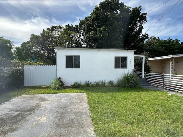 1812 NW 64th St, Miami, FL 33147 - view of home's exterior featuring stucco siding and a patio