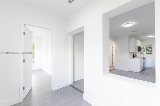 1812 NW 64th St, Miami, FL 33147 - corridor featuring light wood-style floors and baseboards