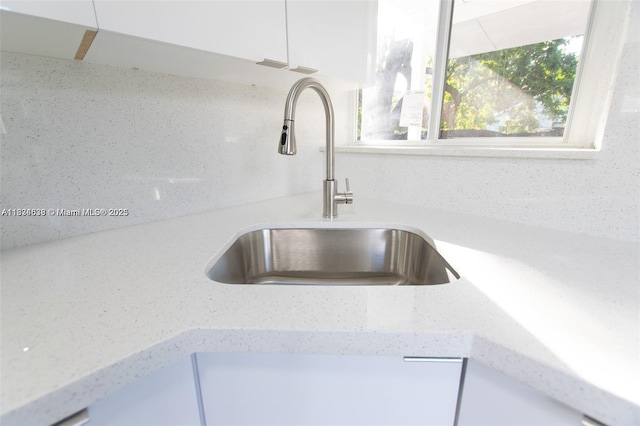 1812 NW 64th St, Miami, FL 33147 - kitchen view of white cabinets and light stone countertops