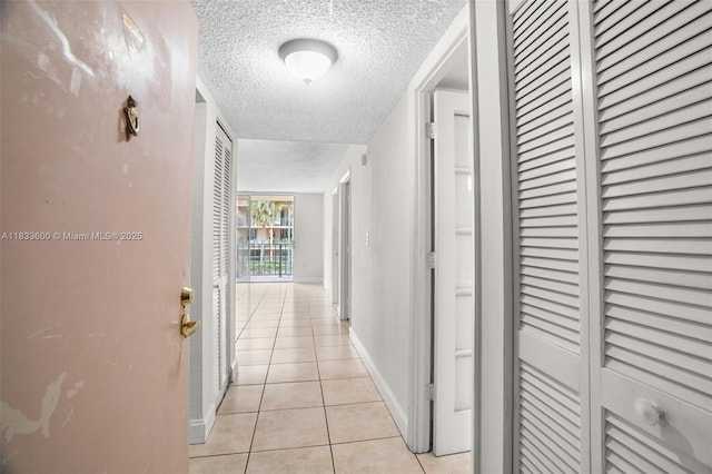 9310 Fontainebleau Blvd Unit 203, Miami, FL 33172 - corridor with light tile patterned flooring and a textured ceiling