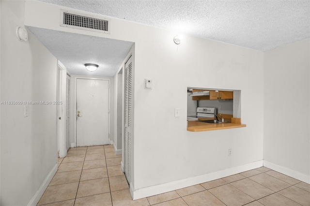 9310 Fontainebleau Blvd Unit 203, Miami, FL 33172 - hall featuring a textured ceiling and light tile patterned floors