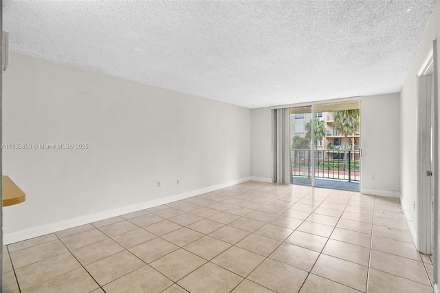 9310 Fontainebleau Blvd Unit 203, Miami, FL 33172 - empty room with a textured ceiling, light tile patterned floors, and a wall of windows