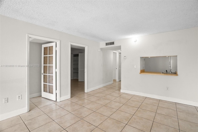 9310 Fontainebleau Blvd Unit 203, Miami, FL 33172 - empty room with a textured ceiling and light tile patterned flooring