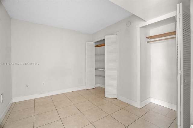 9310 Fontainebleau Blvd Unit 203, Miami, FL 33172 - unfurnished bedroom with light tile patterned floors and baseboards