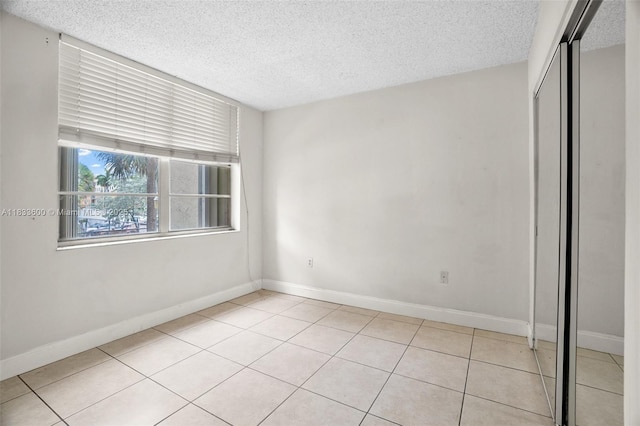 9310 Fontainebleau Blvd Unit 203, Miami, FL 33172 - spare room with a textured ceiling and light tile patterned floors