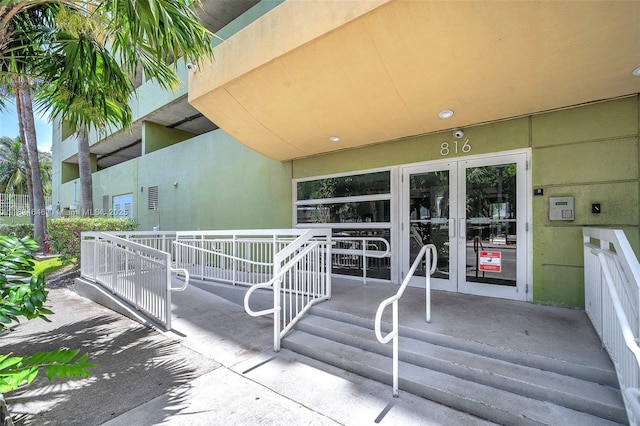 816 NW 11th St Unit 801, Miami, FL 33136 - view of exterior entry featuring french doors and stucco siding