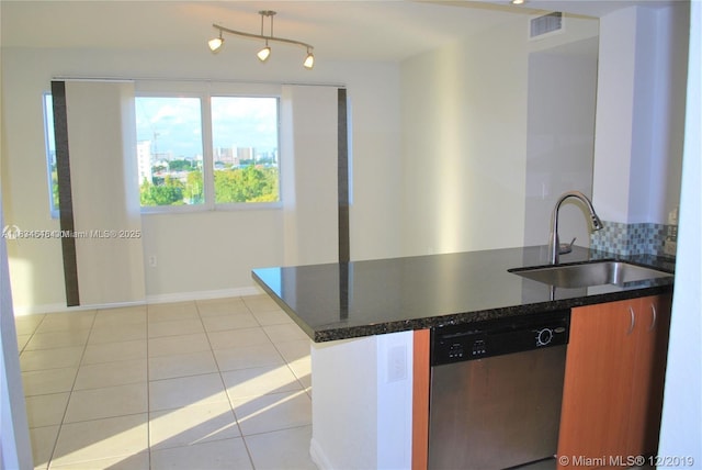 816 NW 11th St Unit 801, Miami, FL 33136 - kitchen with stainless steel dishwasher, light tile patterned floors, backsplash, and a peninsula