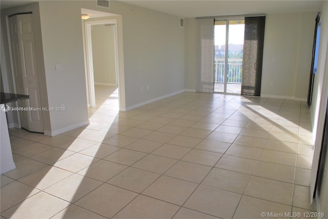 816 NW 11th St Unit 801, Miami, FL 33136 - empty room with light tile patterned floors and floor to ceiling windows