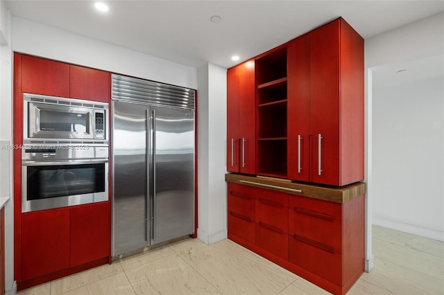 1331 Brickell Bay Dr Unit 2705, Miami, FL 33131 - kitchen with built in appliances, red cabinetry, open shelves, and recessed lighting