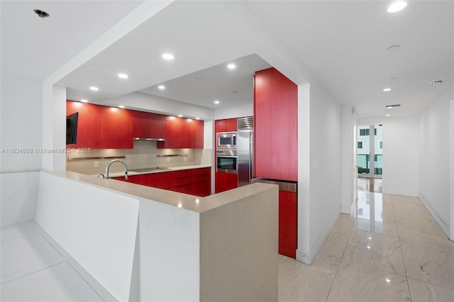 1331 Brickell Bay Dr Unit 2705, Miami, FL 33131 - kitchen with built in appliances, modern cabinets, light marble finish floors, recessed lighting, and light countertops