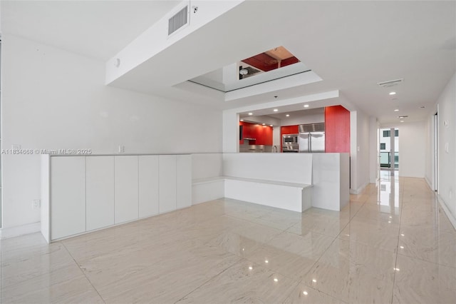 1331 Brickell Bay Dr Unit 2705, Miami, FL 33131 - kitchen featuring built in appliances, recessed lighting, light marble finish flooring, a peninsula, and white cabinets