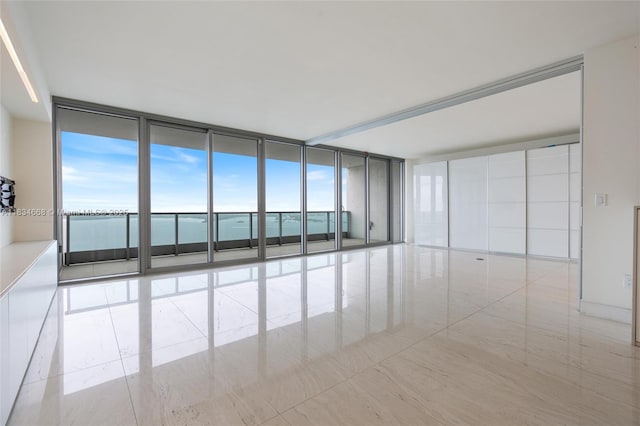 1331 Brickell Bay Dr Unit 2705, Miami, FL 33131 - empty room with expansive windows, healthy amount of natural light, and tile patterned flooring