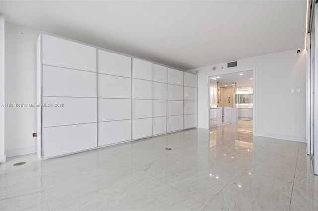 1331 Brickell Bay Dr Unit 2705, Miami, FL 33131 - unfurnished living room with marble finish flooring and baseboards