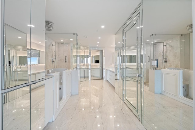 1331 Brickell Bay Dr Unit 2705, Miami, FL 33131 - full bathroom with a garden tub, a shower stall, vanity, marble finish flooring, and recessed lighting