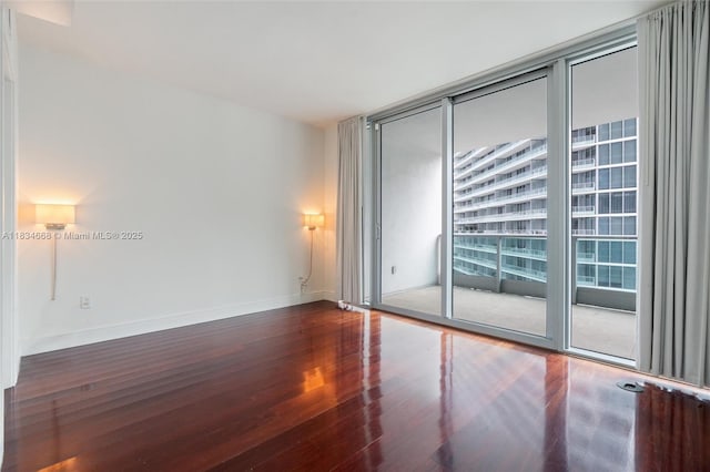 1331 Brickell Bay Dr Unit 2705, Miami, FL 33131 - spare room with wood finished floors and floor to ceiling windows
