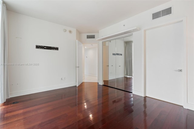 1331 Brickell Bay Dr Unit 2705, Miami, FL 33131 - unfurnished bedroom featuring wood finished floors and a closet
