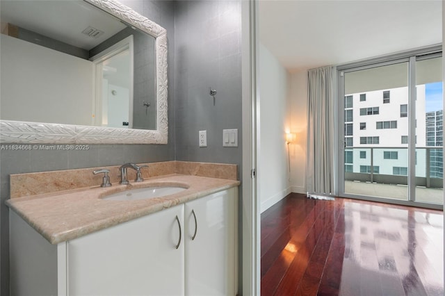 1331 Brickell Bay Dr Unit 2705, Miami, FL 33131 - bathroom featuring wood finished floors, vanity, and expansive windows