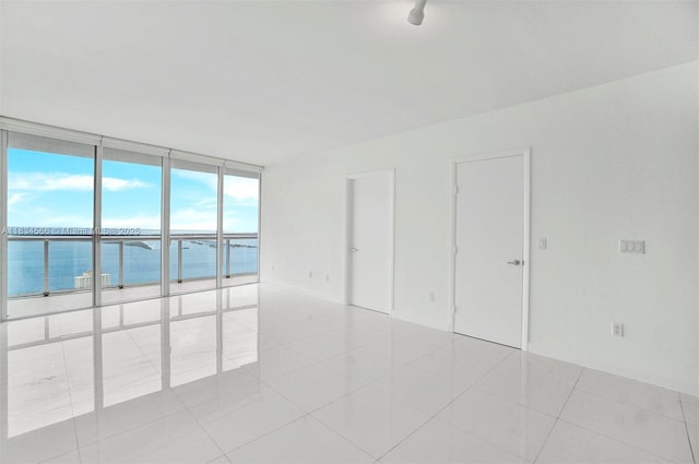 465 Brickell Ave Unit 4505, Miami, FL 33131 - spare room featuring plenty of natural light, a water view, light tile patterned floors, and floor to ceiling windows