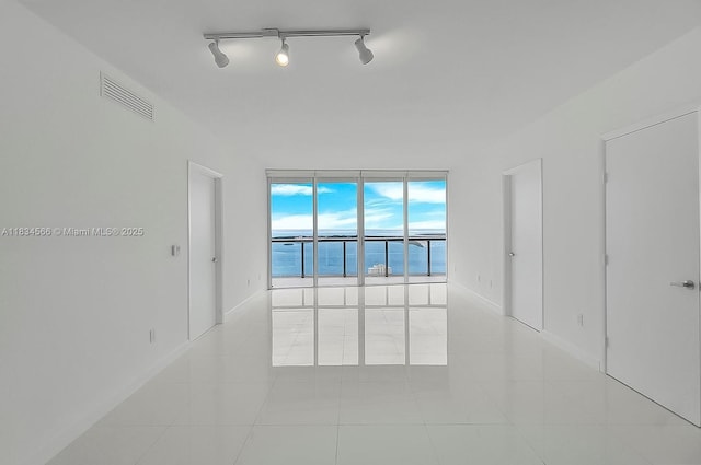 465 Brickell Ave Unit 4505, Miami, FL 33131 - unfurnished room featuring light tile patterned floors and track lighting