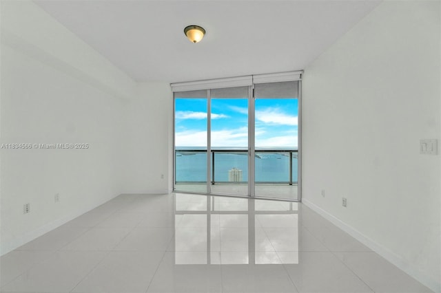 465 Brickell Ave Unit 4505, Miami, FL 33131 - empty room featuring expansive windows and light tile patterned flooring