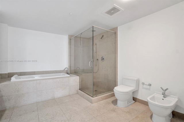465 Brickell Ave Unit 4505, Miami, FL 33131 - full bathroom with a bidet, a garden tub, tile patterned flooring, and a shower stall