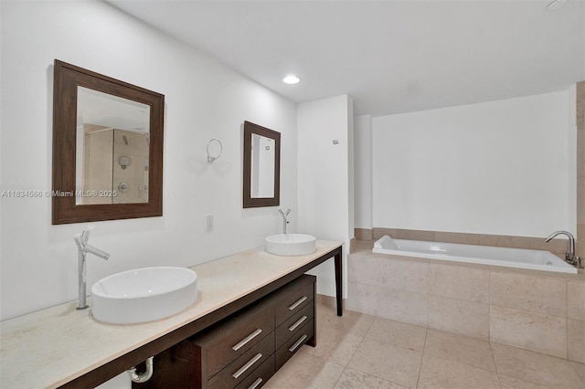 465 Brickell Ave Unit 4505, Miami, FL 33131 - bathroom featuring a garden tub, double vanity, and tile patterned floors