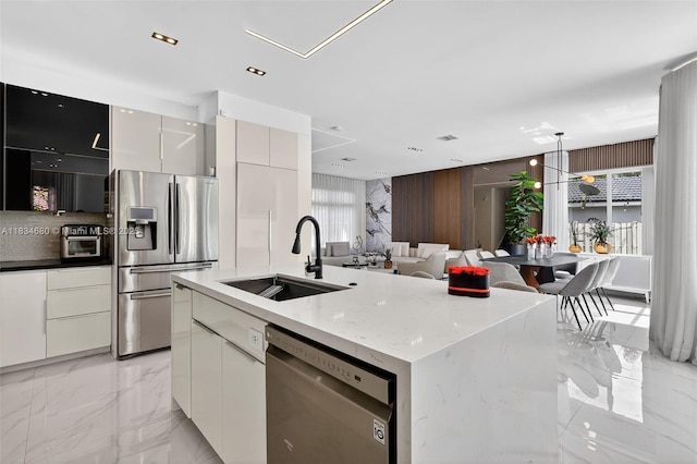 2036 SW 159th Ave, Miramar, FL 33027 - kitchen with stainless steel appliances, modern cabinets, light marble finish flooring, a center island with sink, and open floor plan