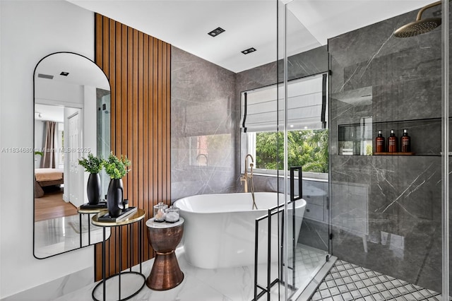 2036 SW 159th Ave, Miramar, FL 33027 - ensuite bathroom with a soaking tub, a stall shower, and tile walls