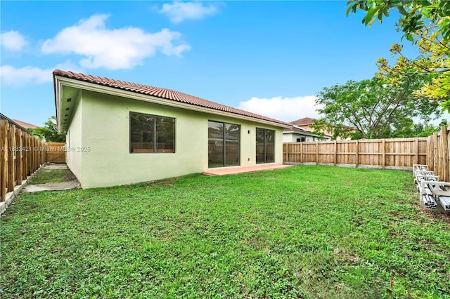 22486 SW 110th Ct, Miami, FL 33170 - rear view of house with stucco siding, a fenced backyard, a tile roof, and a patio area