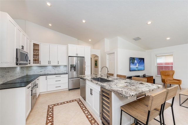 1583 SW 191st Ave, Pembroke Pines, FL 33029 - kitchen with vaulted ceiling, appliances with stainless steel finishes, beverage cooler, recessed lighting, and tasteful backsplash