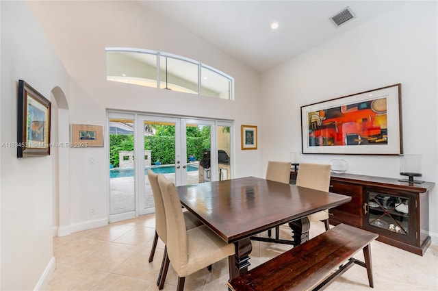 1583 SW 191st Ave, Pembroke Pines, FL 33029 - dining room featuring french doors, a high ceiling, light tile patterned floors, arched walkways, and recessed lighting