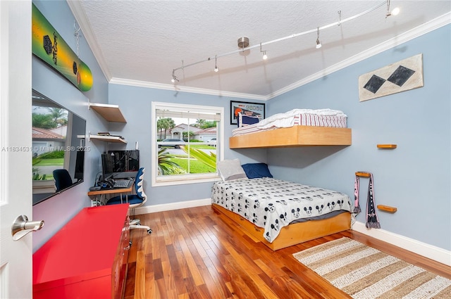 1583 SW 191st Ave, Pembroke Pines, FL 33029 - bedroom with crown molding, track lighting, wood-type flooring, and a textured ceiling