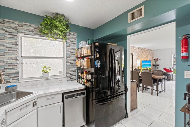 8577 W Boca Glades Blvd Unit D, Boca Raton, FL 33434 - kitchen with black refrigerator with ice dispenser, dishwasher, light tile patterned floors, and decorative backsplash