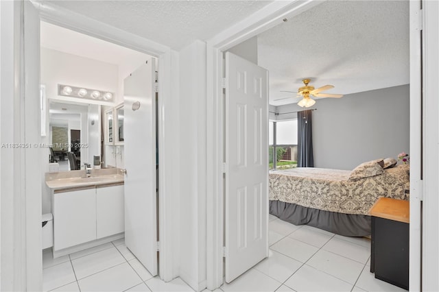 8577 W Boca Glades Blvd Unit D, Boca Raton, FL 33434 - bathroom with a ceiling fan, vanity, tile patterned flooring, a textured ceiling, and ensuite bath
