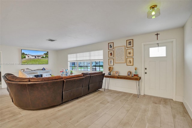 7735 Edgewater Dr, Lake Clarke Shores, FL 33406 - living room featuring light wood-type flooring and healthy amount of natural light