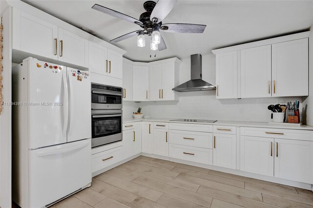 7735 Edgewater Dr, Lake Clarke Shores, FL 33406 - kitchen featuring freestanding refrigerator, wall chimney range hood, double oven, black electric cooktop, and light countertops