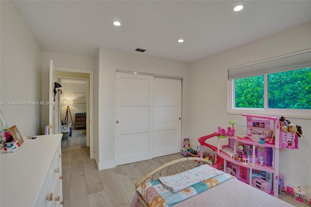 7735 Edgewater Dr, Lake Clarke Shores, FL 33406 - bedroom with light wood-type flooring, a closet, and recessed lighting