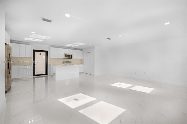 324 SW 16th Ter, Homestead, FL 33030 - unfurnished living room with recessed lighting and light marble finish floors
